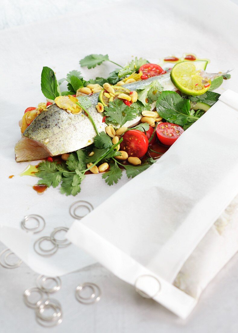 Trout in baking parchment with peanuts and coriander