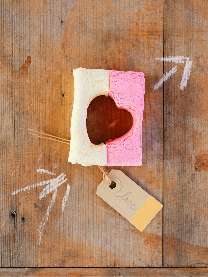 A heart cut out of two colourful marshmallows