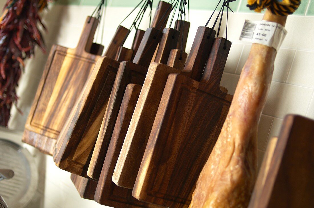 Chopping boards hanging up in a kitchen