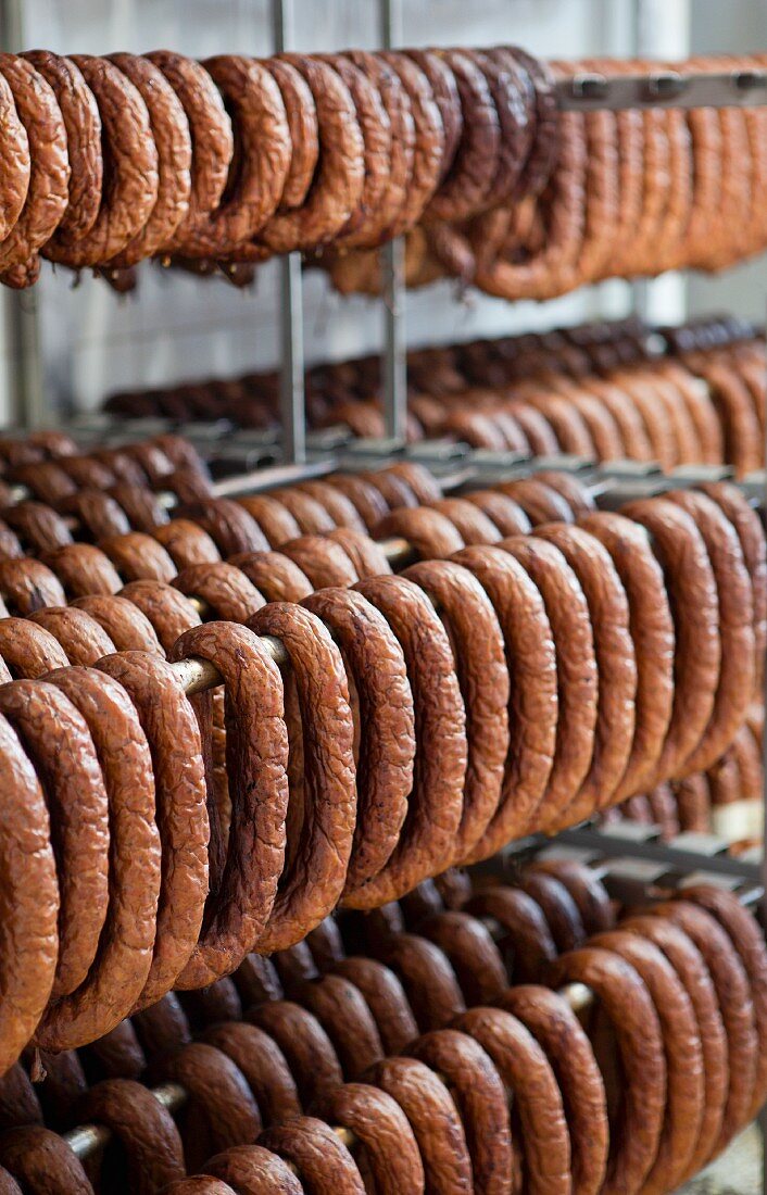 Lots of sausages hanging in a smoke house