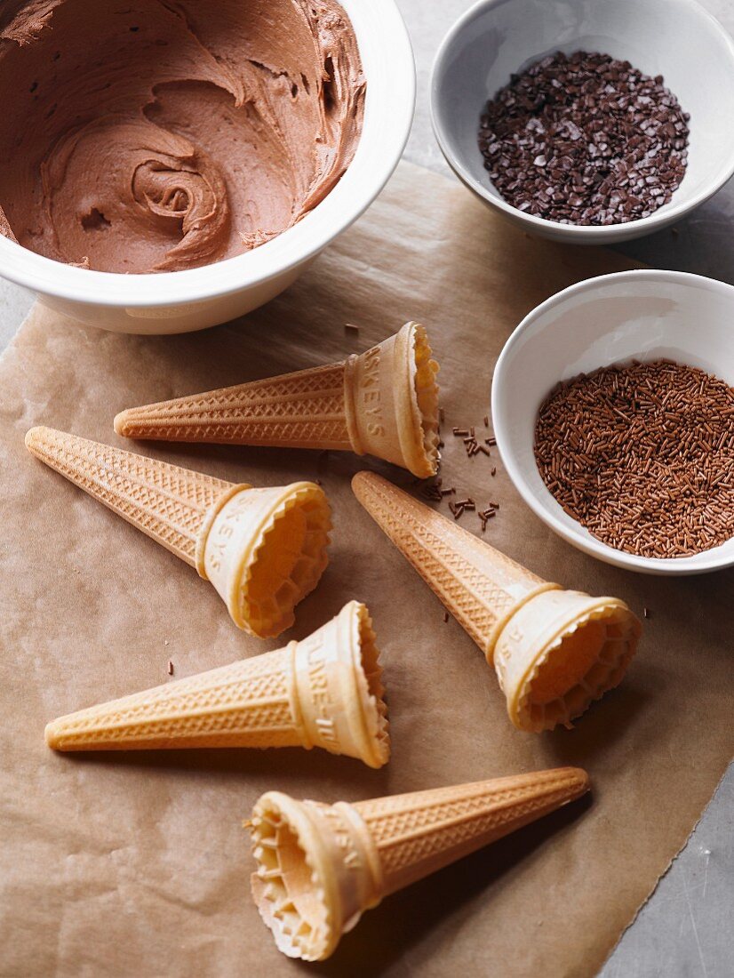 Ice cream cones, chocolate buttercream and grated chocolate for decorating a cake