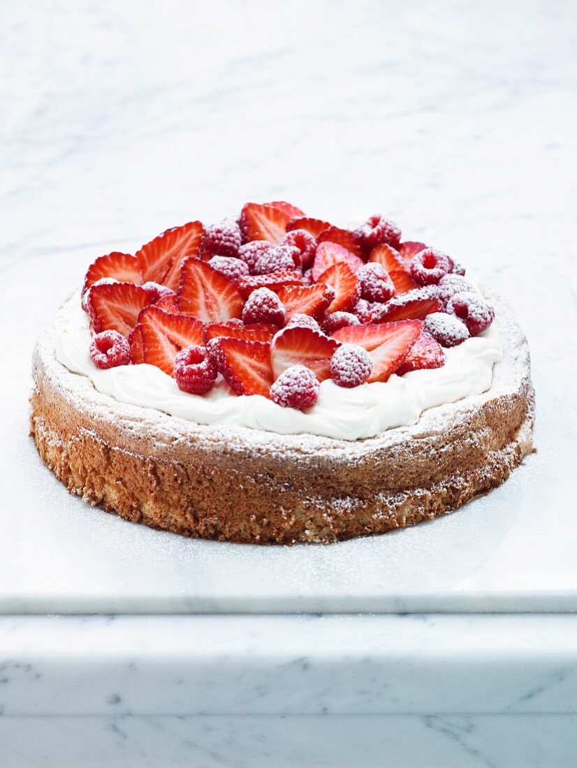 Hazelnut cake with meringue, strawberries and raspberries