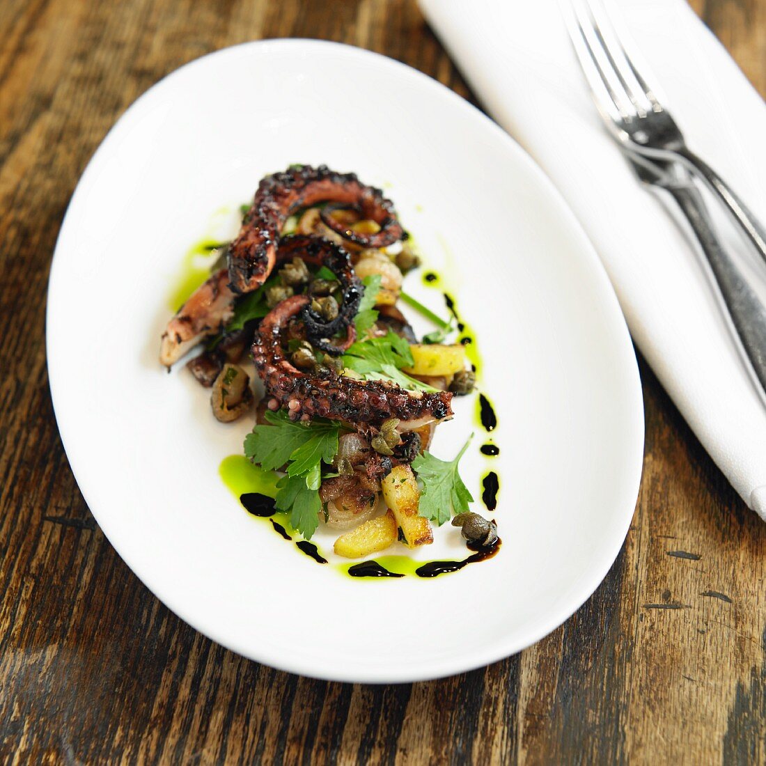 Grilled Octopus with Pickled Eggplant, Fingerling Potatoes, Herb Salad and Red Pearl Onions