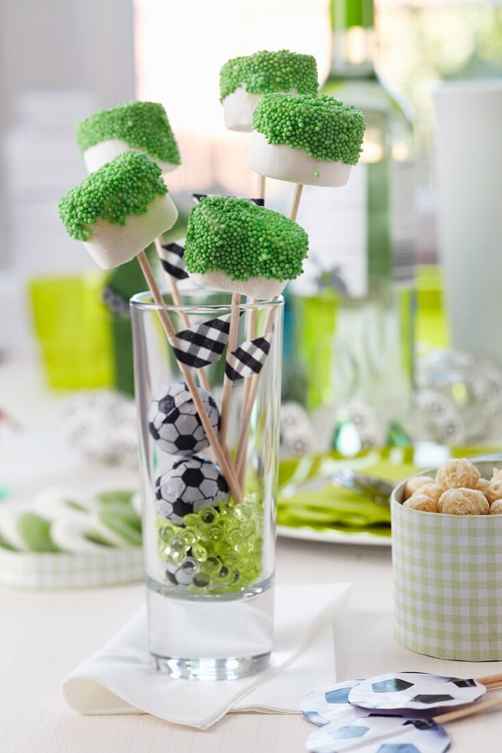 Marshmallows on sticks dipped in green sugar sprinkles