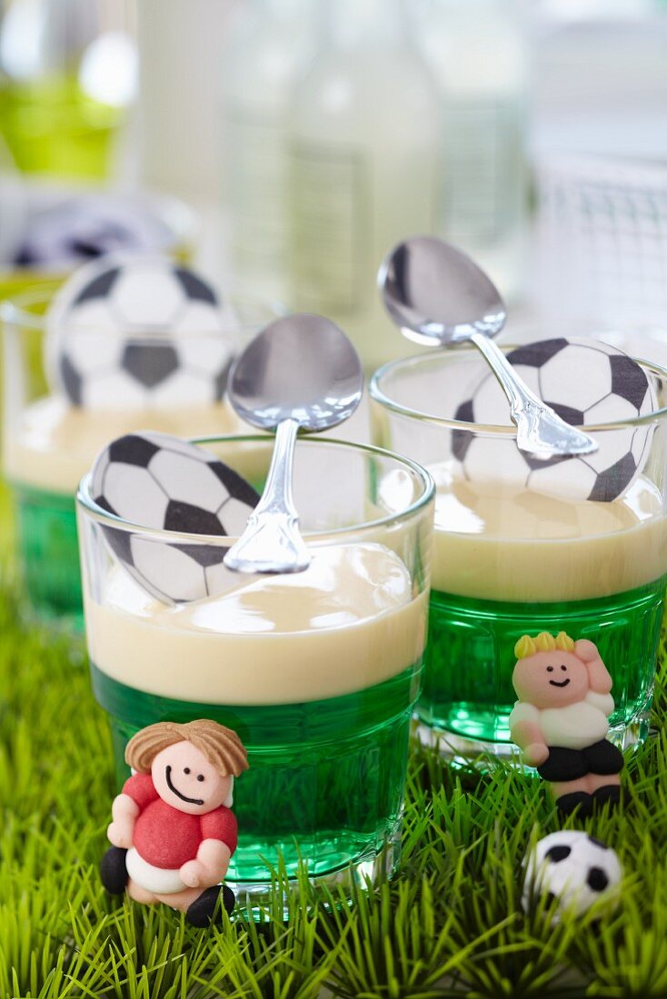 Green jelly with vanilla sauce and football decorations
