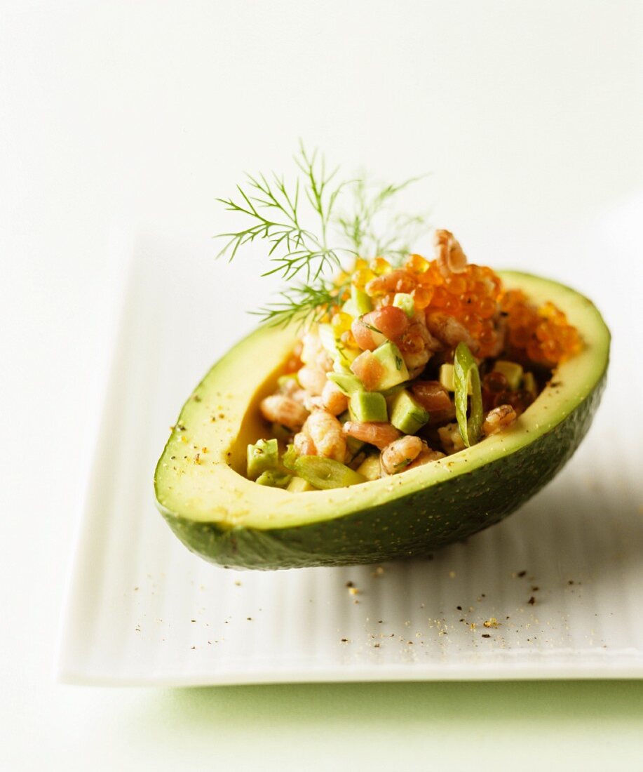 Avocado and prawn salad in a hollowed-out avocado topped with caviar