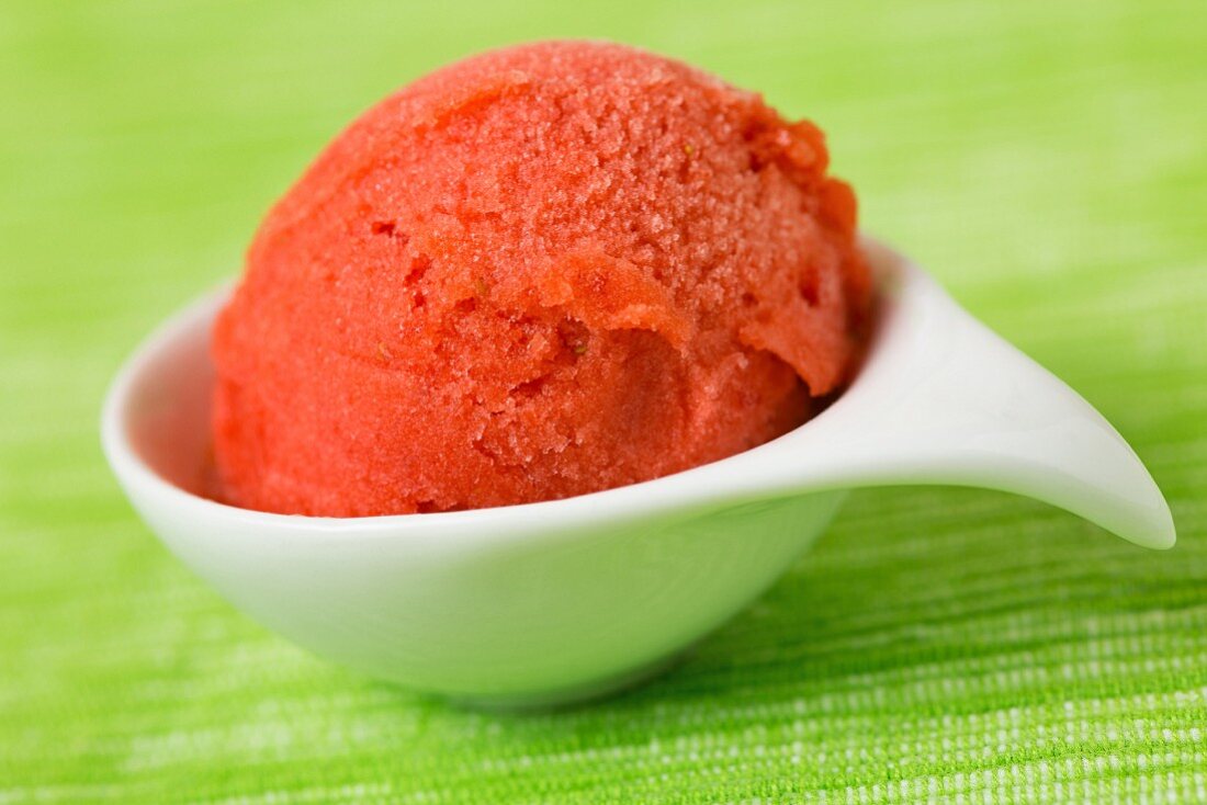 A scoop of home-made strawberry sorbet in a bowl