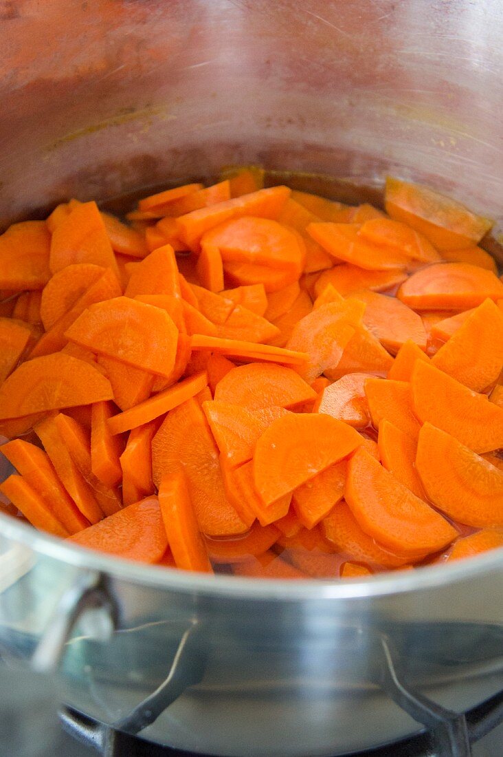 Sliced carrots being boiled in water