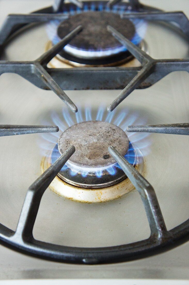 Lit gas rings on the hob (close-up)