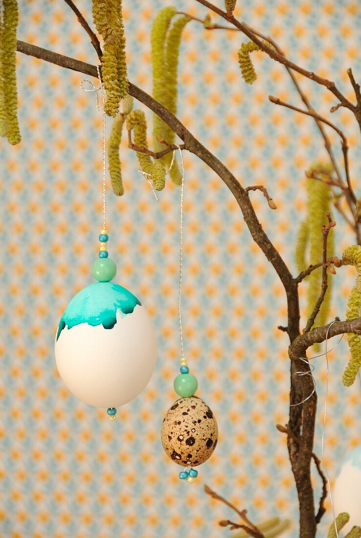 Painted eggs hanging from hazel branch