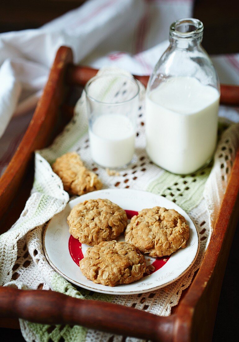 Anzac biscuits and milk on a tray (Australia)