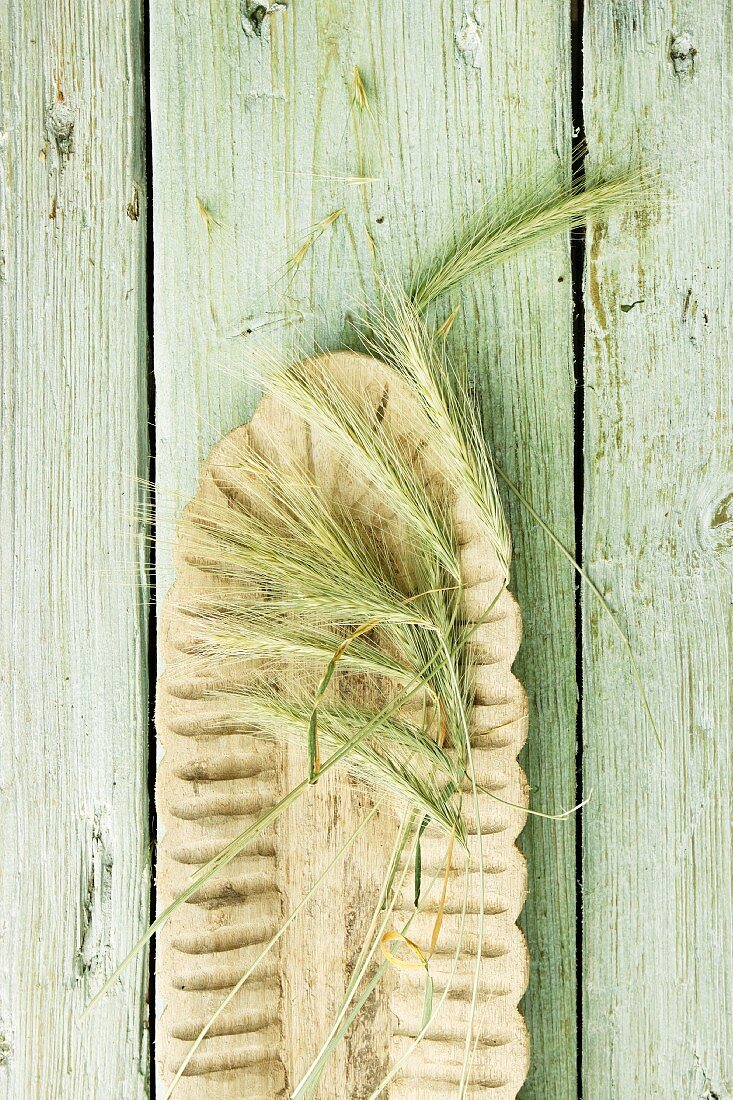 Ears of barley on a wooden surface (view from above)