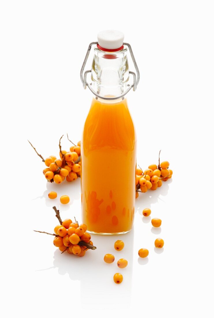 Sea buckthorn juice in a stoppered bottle