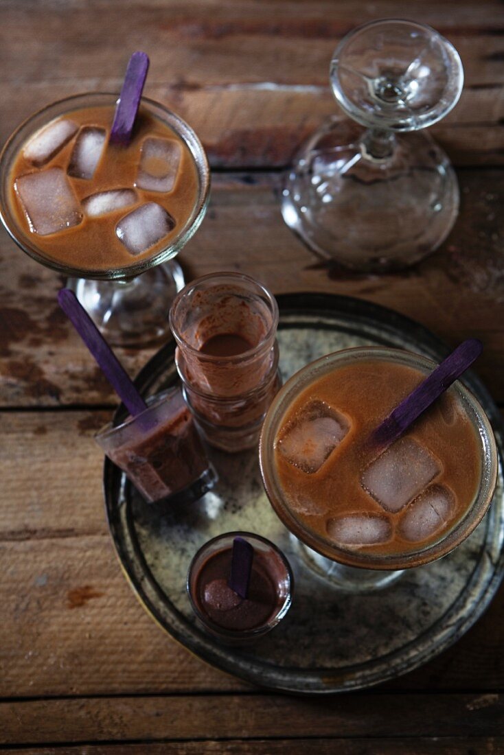 Two iced coffees with chocolate shooters