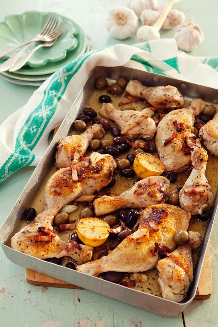 Provençal chicken legs with olives and lemons in a roasting tin