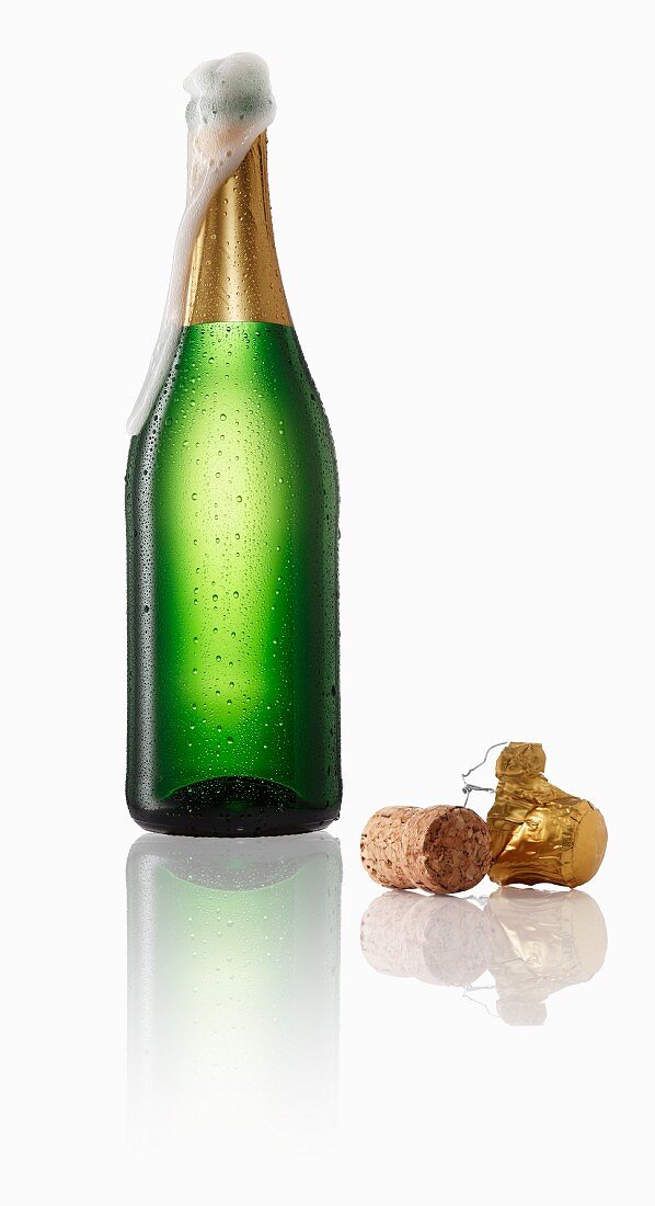 Sparkling wine bubbling out of the bottle