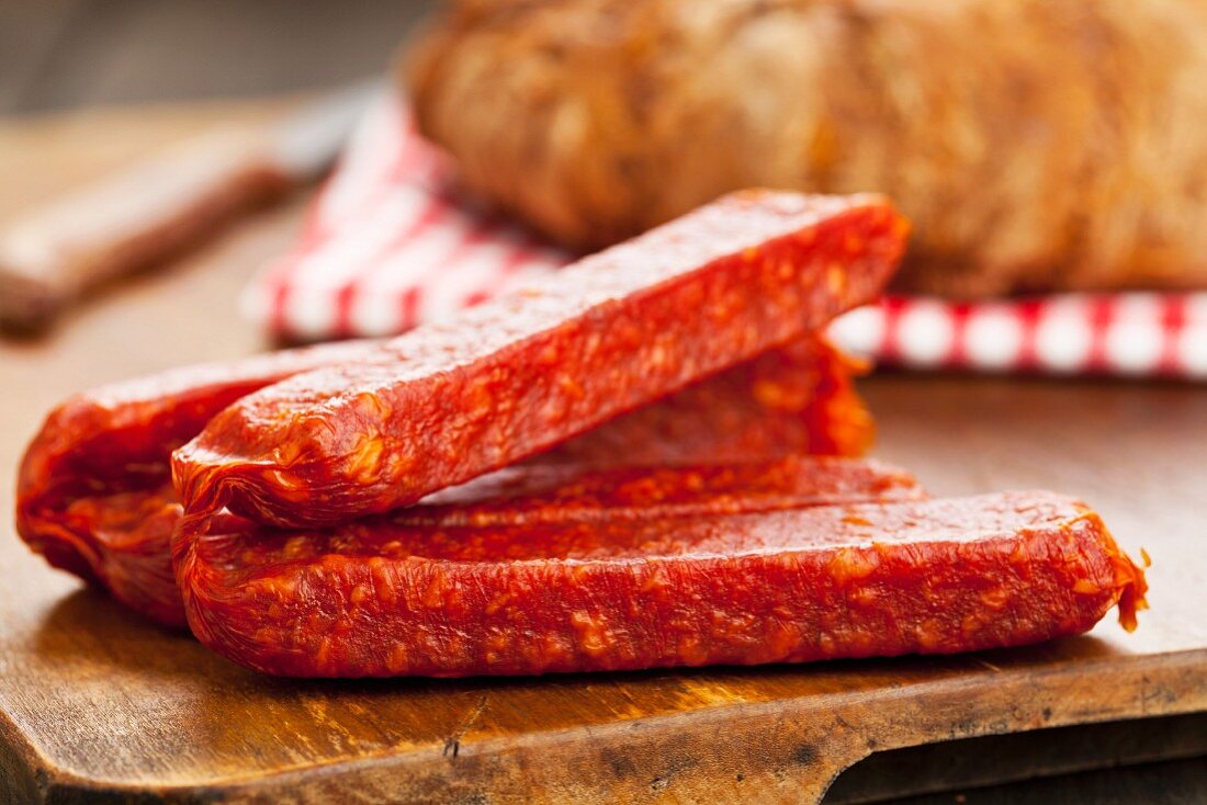 Landjäger (Salamispezialität) auf Holzbrett mit Bauernbrot