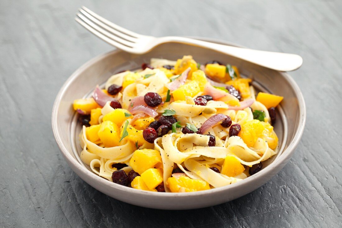 Tagliatelle with pumpkin, cranberries and parsley
