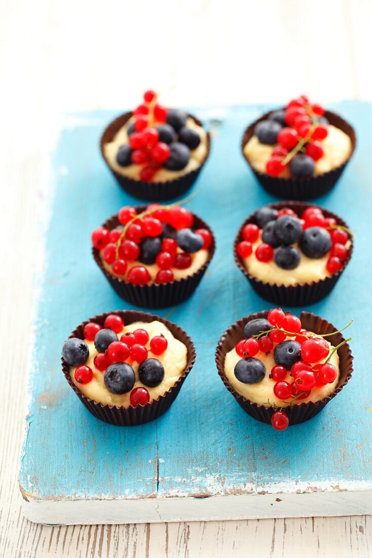 Chocolate cups filled with custard and berries