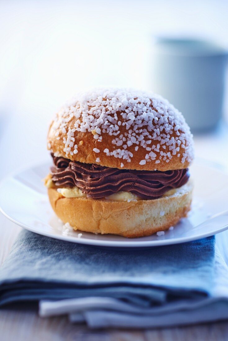 A sweet bread roll filled with chocolate and vanilla cream