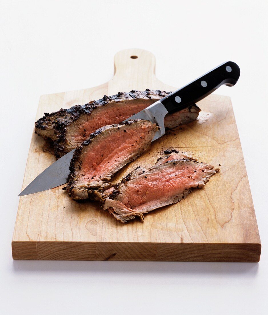 Sliced roast beef on a chopping board