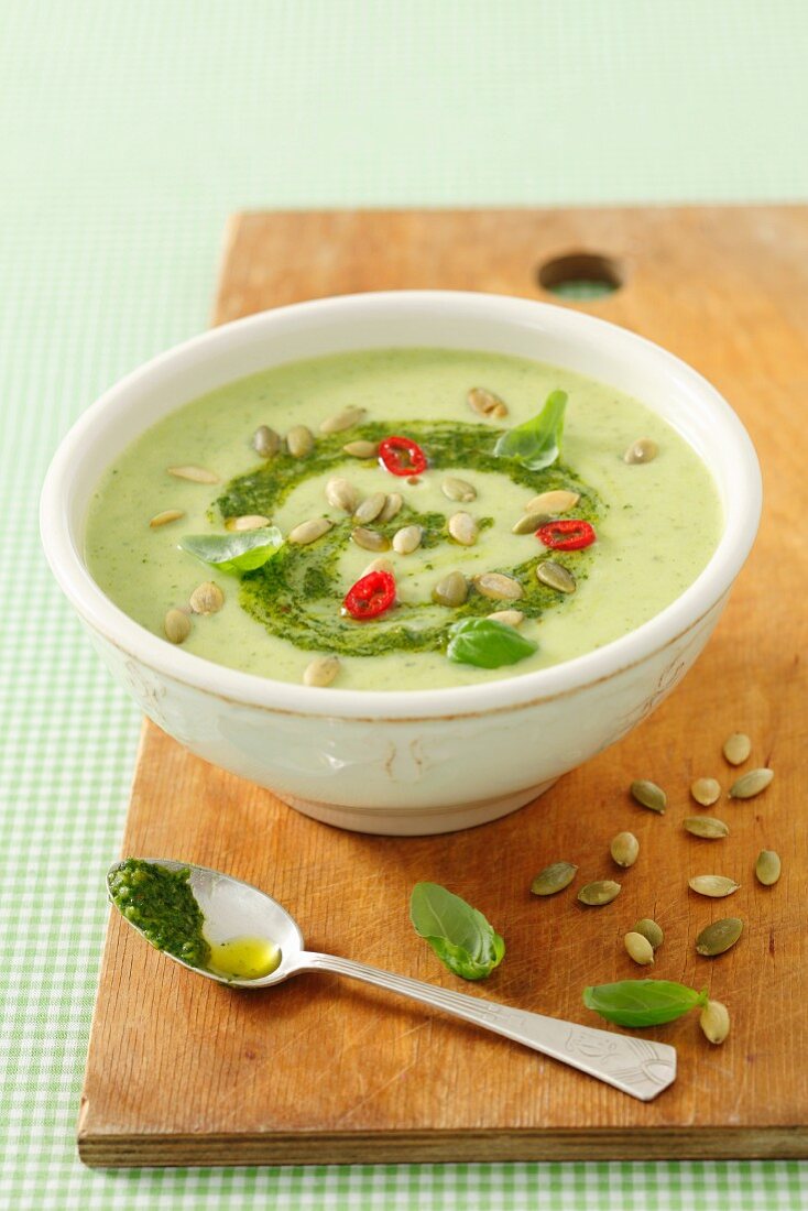 Cream of courgette soup with pesto and pumpkin seeds
