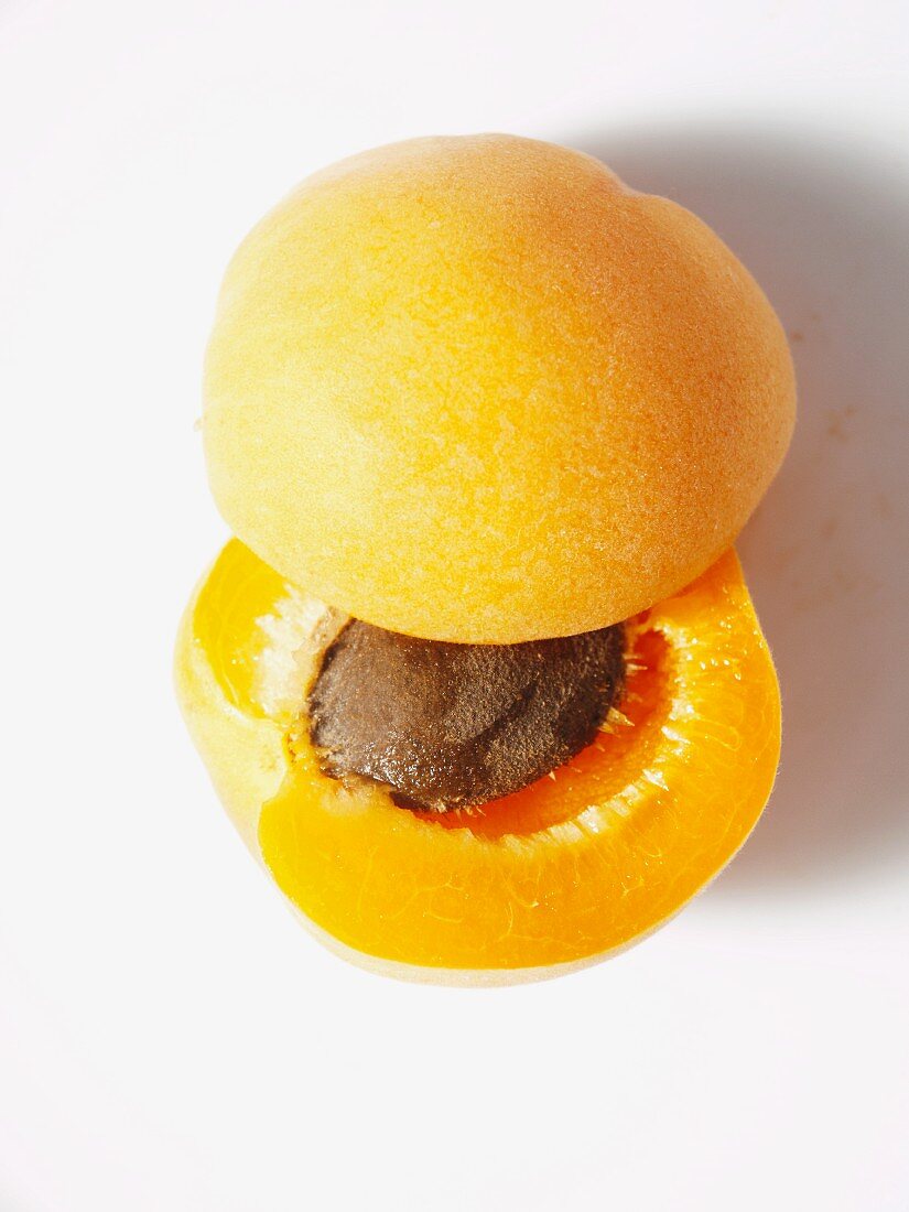 An apricot cut in half to reveal the stone