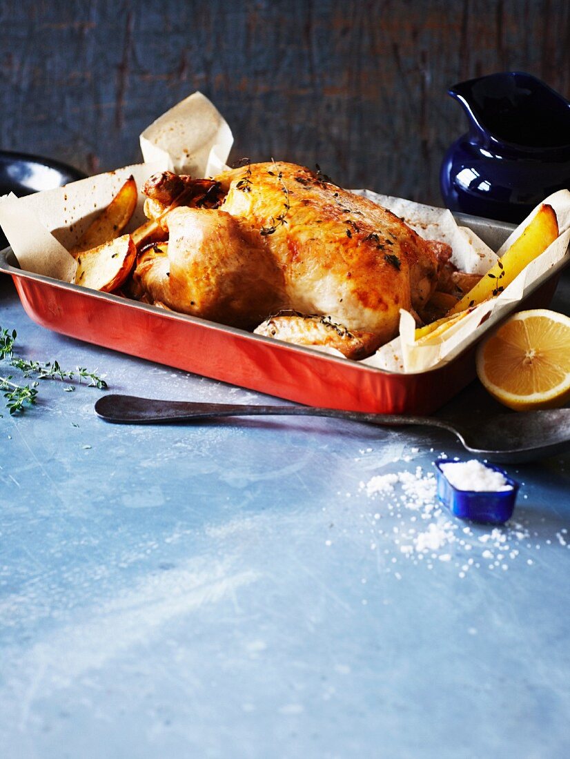 Roast chicken with lemon, thyme and potato wedges