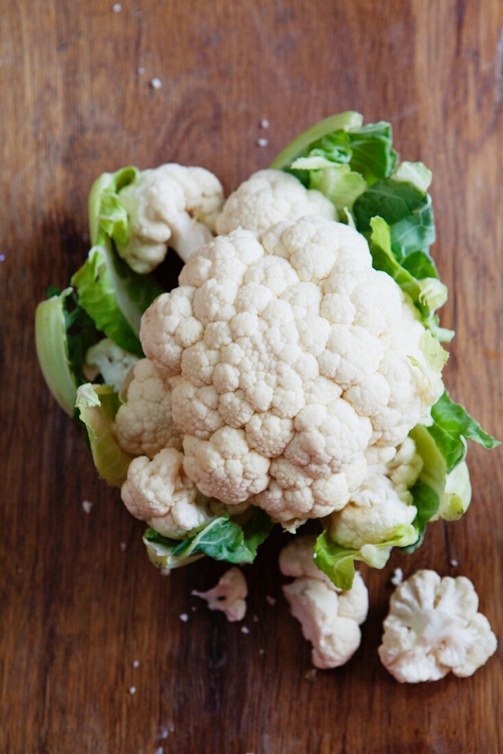 A cauliflower on a wooden board