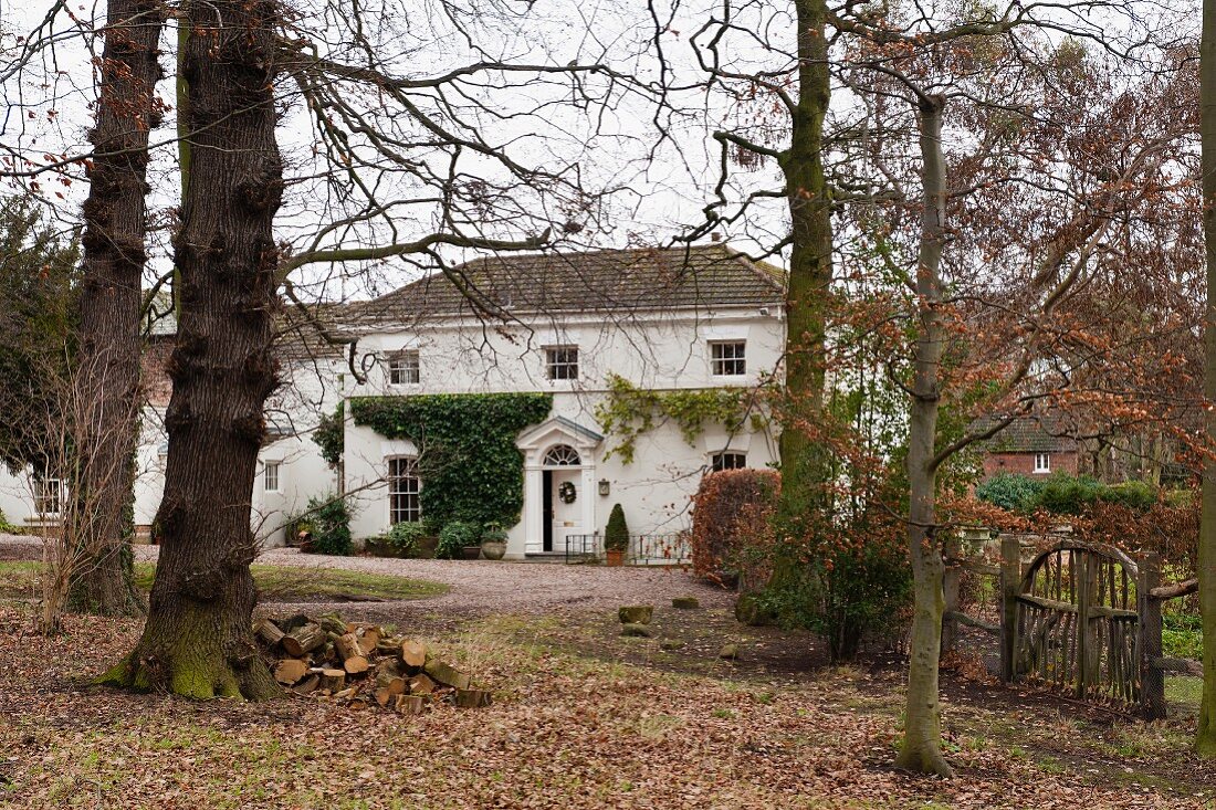 Autumnal garden with view of traditional English country house