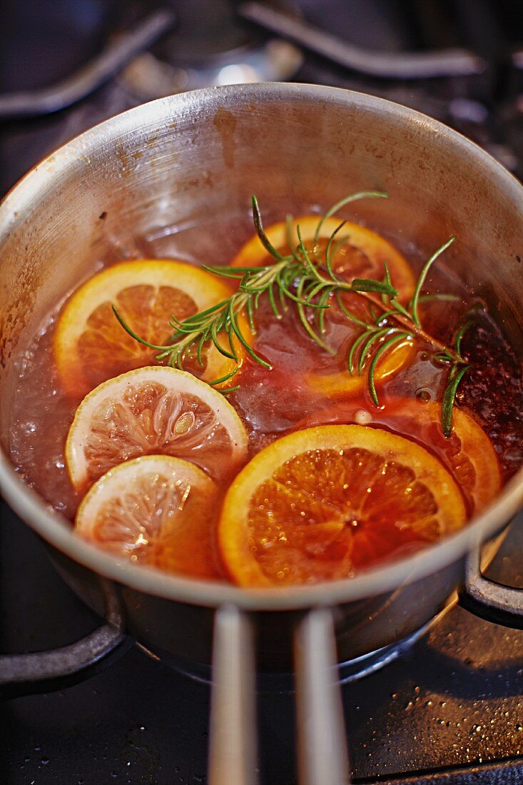 Oranges in red wine sauce with rosemary