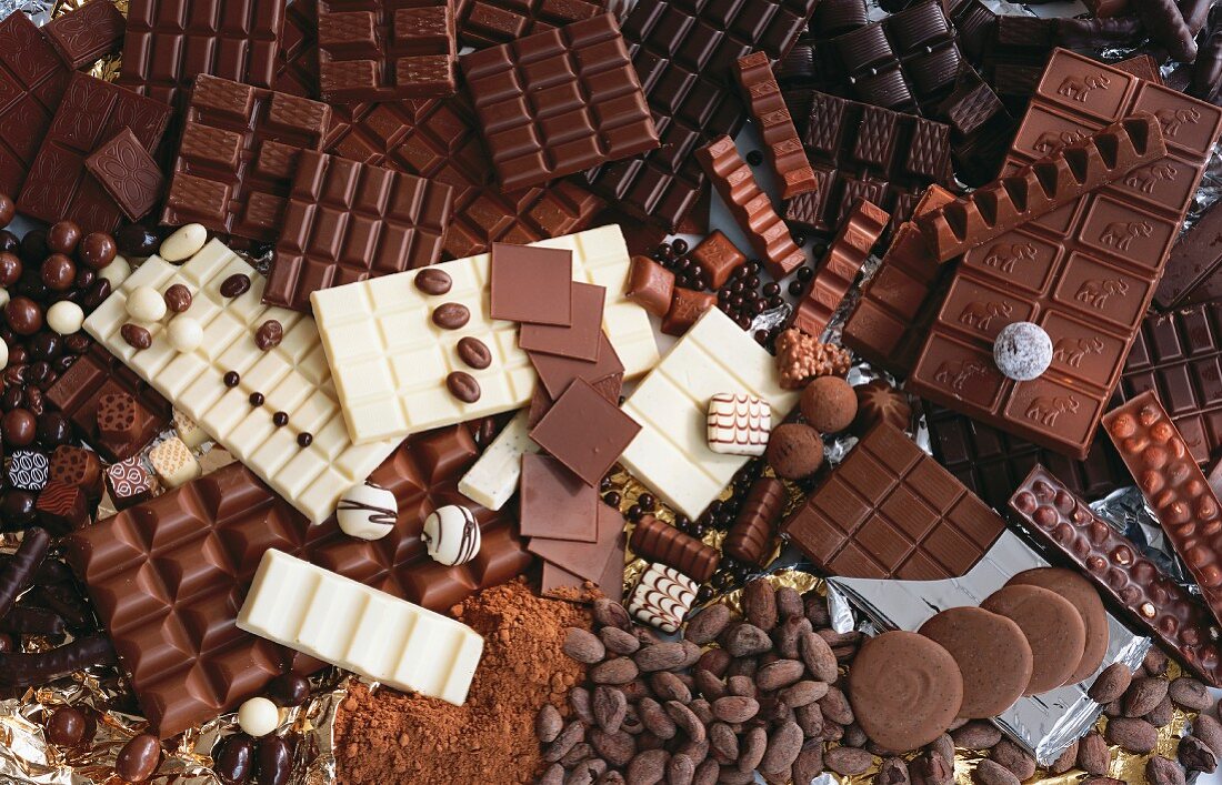 Viele verschiedene Schokoladensorten, Pralinen und Kakaopulver