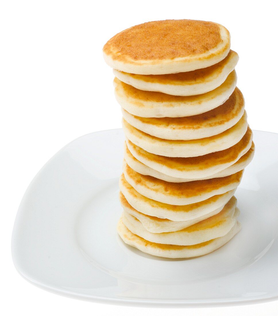 Tall Stack of Pancakes on a White Plate