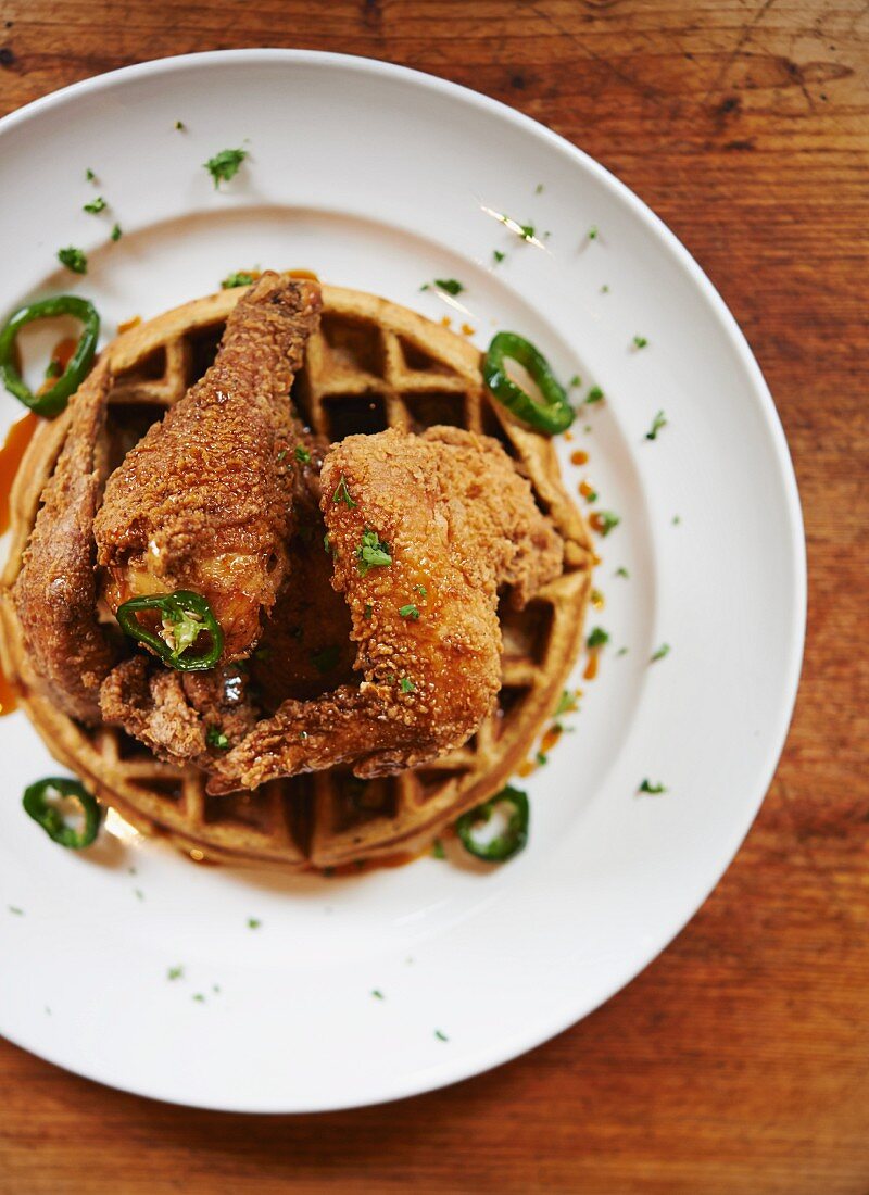 Waffeln mit frittierten Hähnchenkeulen, Ahornsirup und Jalapenos