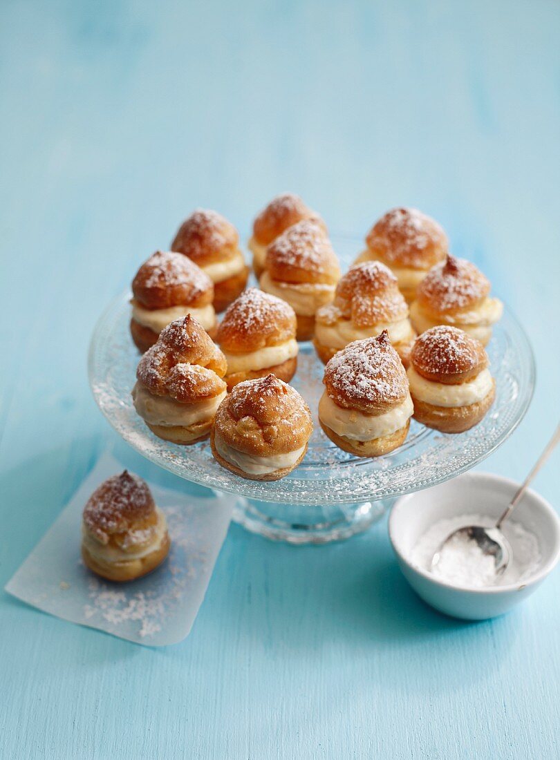 Small profiteroles filled with crème pâtissière and dusted with icing sugar