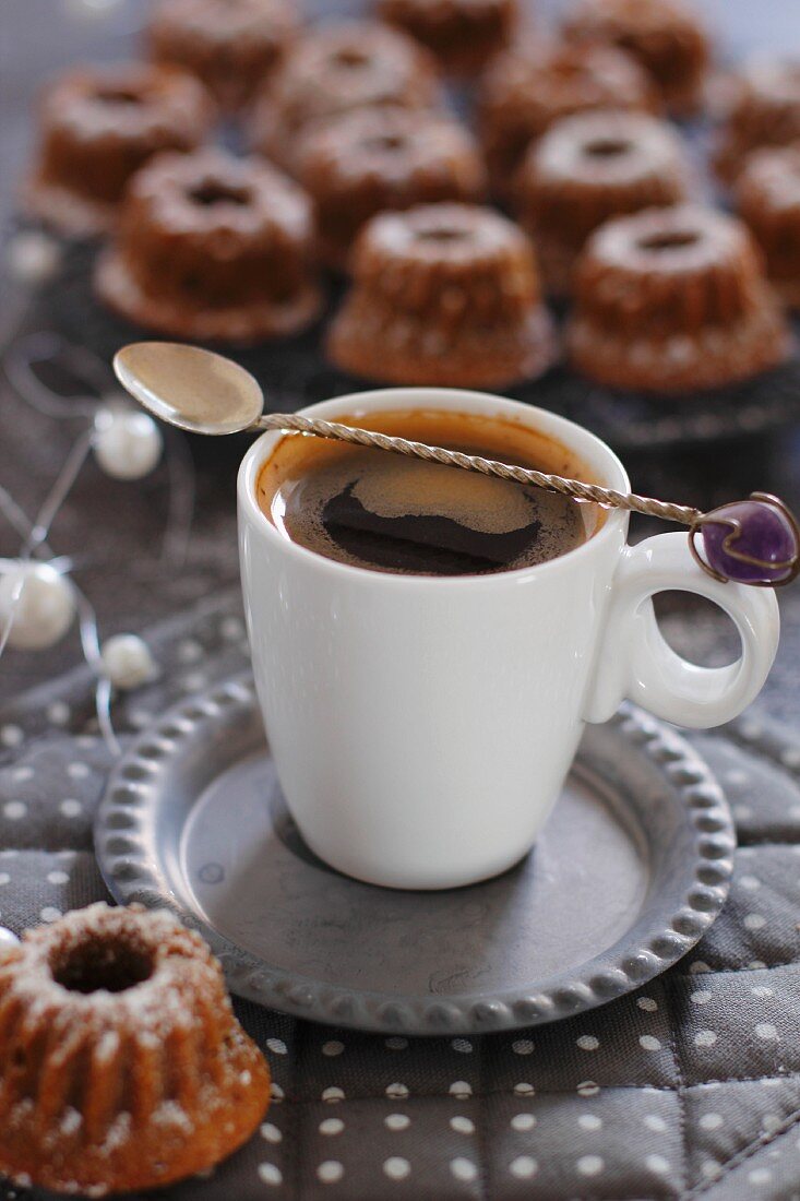 A cup of espresso and mini Bundt cakes