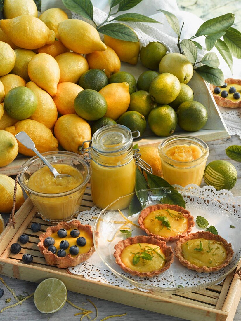 Lemon curd and lime curd in jars; tartlets with lemon curd and lime curd