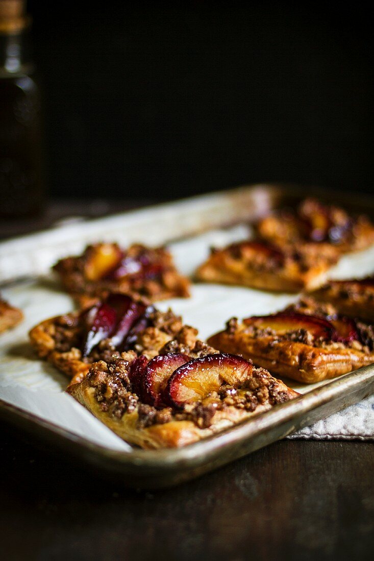 Puff Pastry Squares with Red Plum Crumble on a Baking Sheet