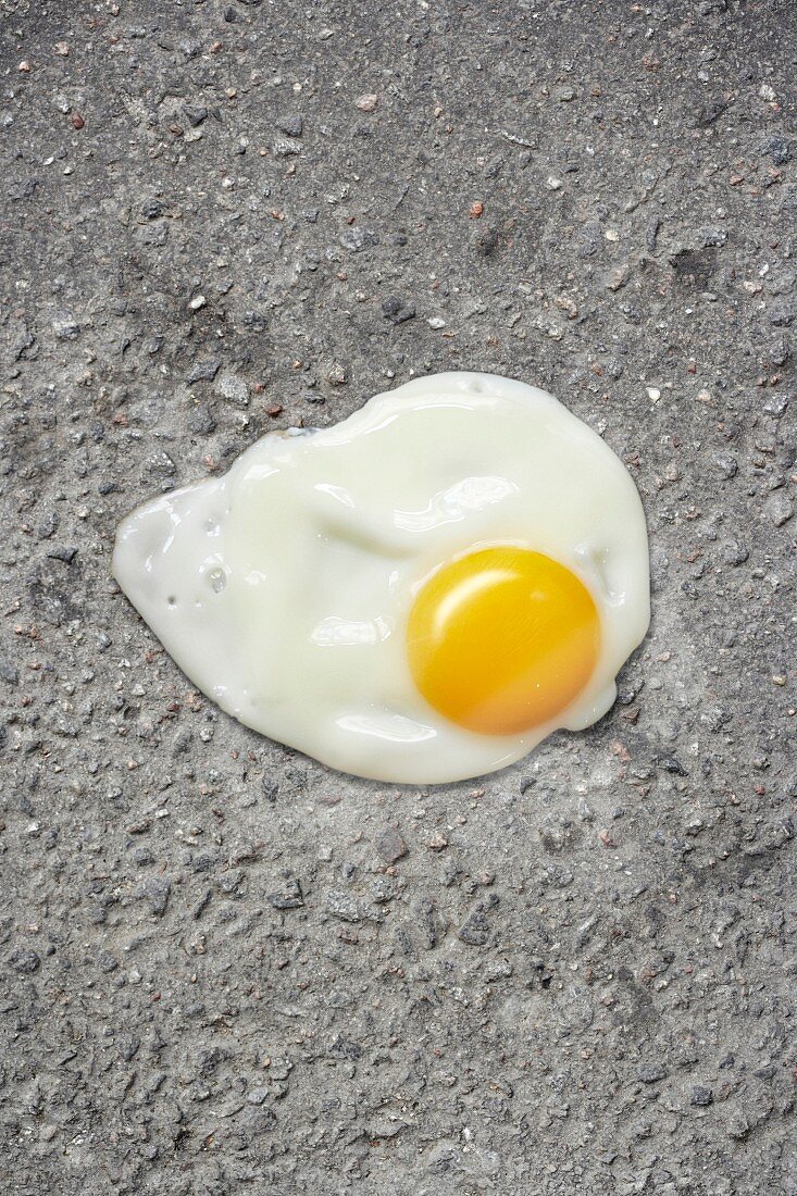 Egg yolk against asphalt