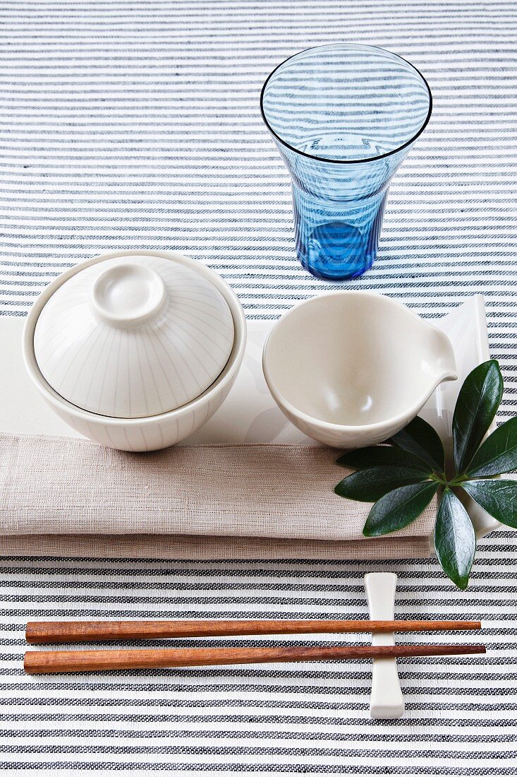 Place setting with napkin, bowl, glass and chopsticks
