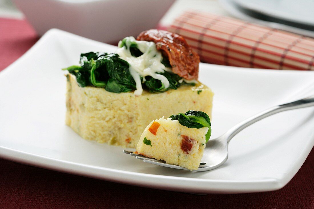 Polenta with sundried tomatoes, spinach and cheese