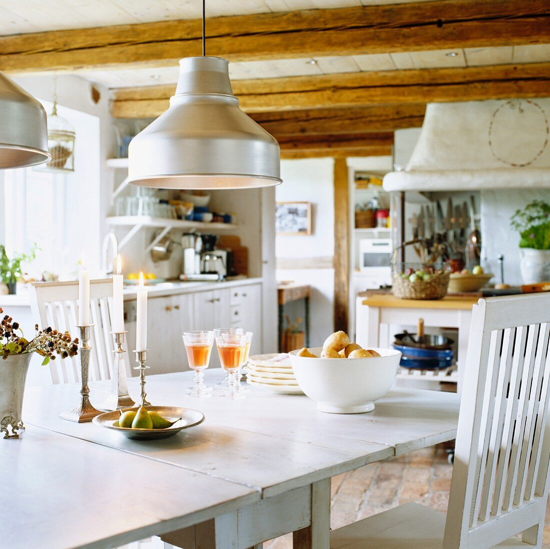 Dining table in rustic kitchen with wood-beamed ceiling