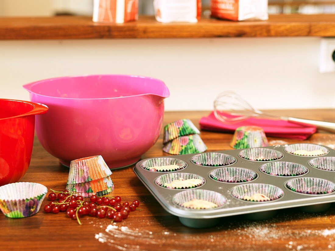 Sweden, Stockholm, Bromma, bowls, cupcake holders, muffin tin, redcurrants on kitchen counter