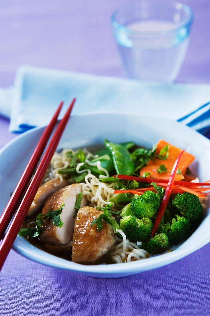 Bowl of chicken and vegetable with chopsticks