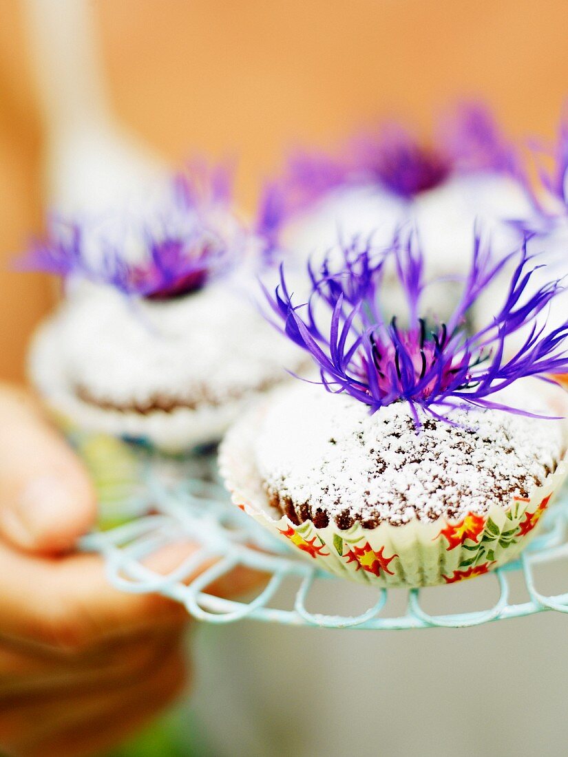 Muffins with flowers, close-up.
