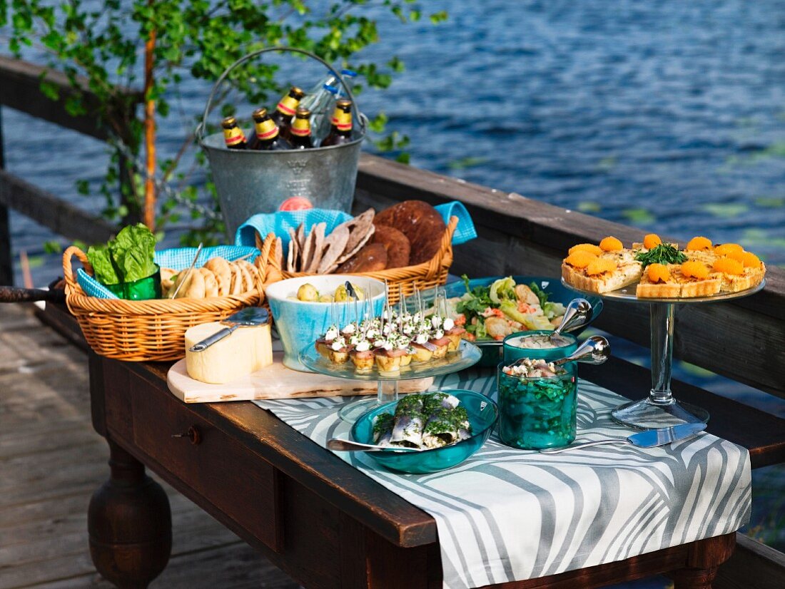 Mittsommer-Buffet auf einem Bootssteg am See (Schweden)