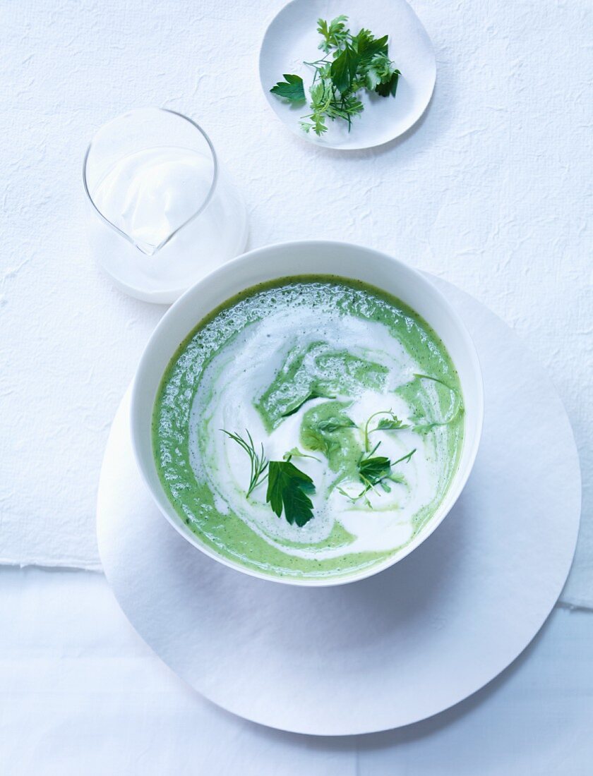 Green herb soup with lemon cream