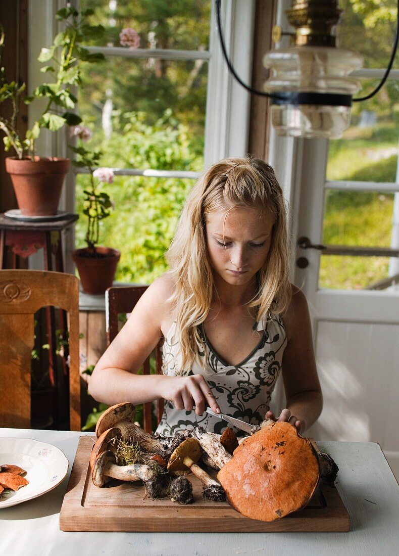 A girl cleaning mushrooms.