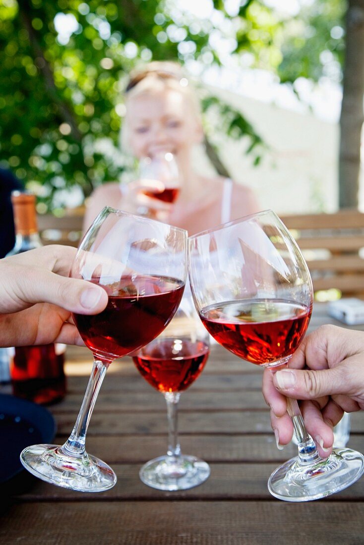 Human hands toasting with wine glasses