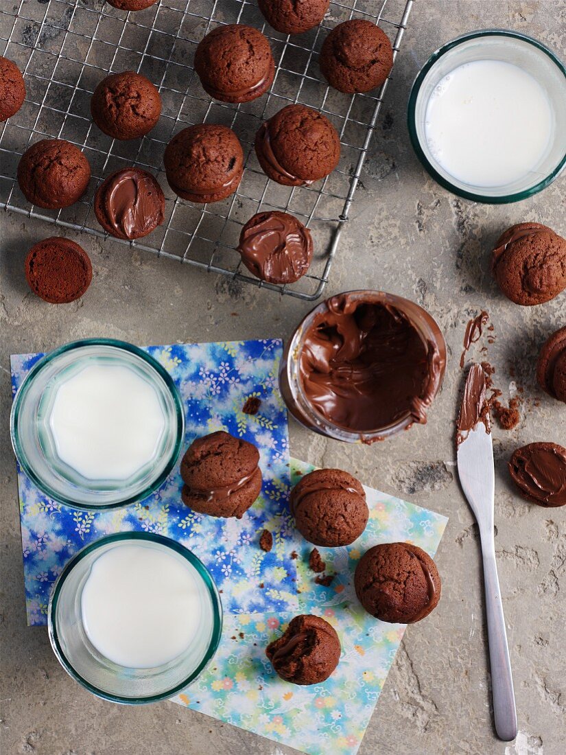 Whoopie Pies with chocolate filling and glasses of milk